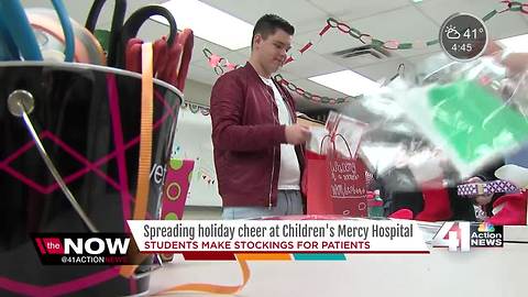 High school students stuff stockings for kids fighting cancer