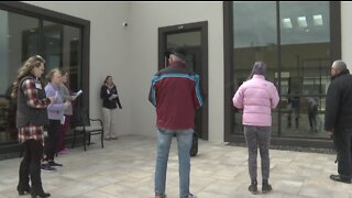 Volunteers singing outside assisted living facilities to bring residents cheer