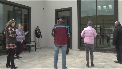 Volunteers singing outside assisted living facilities to bring residents cheer