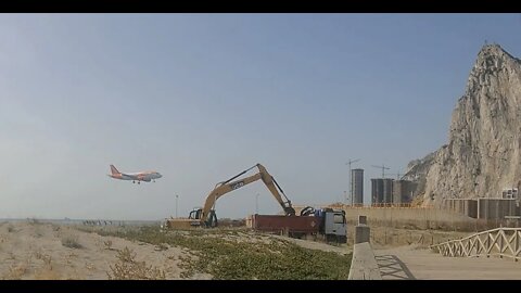 PLANE SPOTTING GIBRALTAR, LGW flight Lands/Departs with JCB Excavator doing work in the Foreground