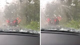 People wait in their car after surprise extreme hail storm