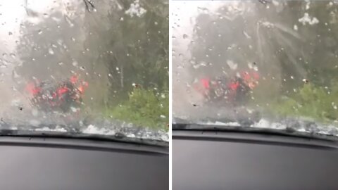 People wait in their car after surprise extreme hail storm