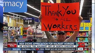 Man thanks Walmart employees with sign