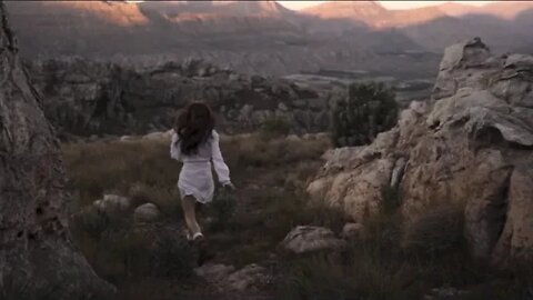 Woman Running on a Rocky Mountain