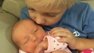 Brother shows his love for newborn sister