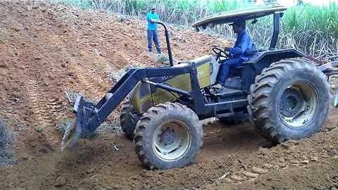 Valtra tractor working with blade and plow