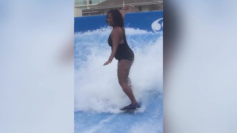 Hilarious Woman Wipes Out While On A Surfboard Simulator