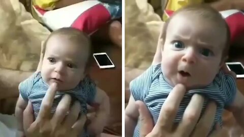 Daddy is giving funny voice to his baby which is hilarious