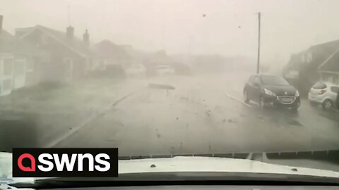 UK driving instructor has lucky escape after mini-tornado blows FENCE across busy road