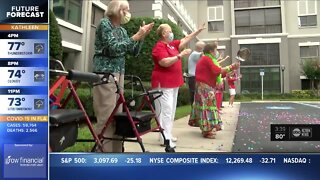 Retirement community staff hosts weekly parade for residents