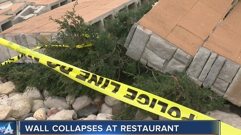 Wind blows down restaurant wall with customers inside