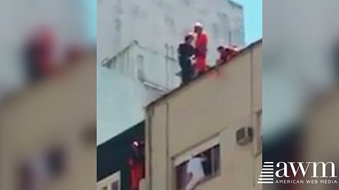 Footage Of Rescue Workers Jumping Off High-Rise Roof To Save Suicidal Man Goes Viral