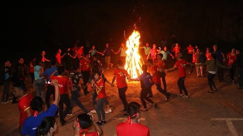 Hand in hand campfire dance in forest at night