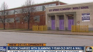 Tutor charged with slamming 7-year-old claims boy had gun