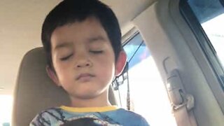 Toddler so tired he sleeps standing up