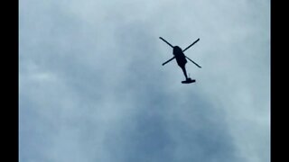 Just a Sikorsky Black Hawk UH-60 helicopter flying over traffic