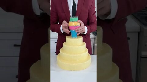 The icing dumps down each layer of the cake perfectly when he lifts the cup!