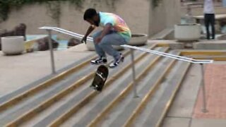 Skater does impressive half cab flip trick on stairs