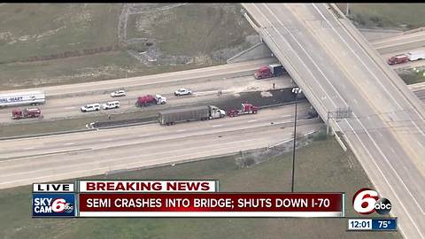 Semi crashes into bridge, oil spilled on I-70