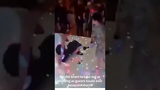 Playful brawl breaks out at wedding as guests tussle over bouquet#shorts
