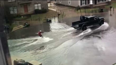 Guy goes water skiing during floods