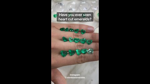 Loose Colombian emeralds heart shape on hand with price and certified