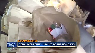 Teens distribute lunches to the homeless in Milwaukee's 'Tent City'