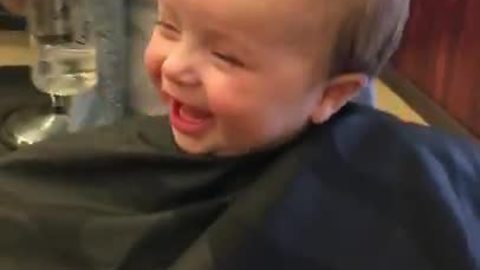 Cheerful Baby Boy Loves His First Haircut