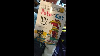 First grader reading Pete the Cat book
