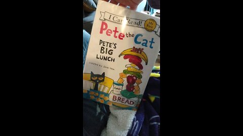 First grader reading Pete the Cat book