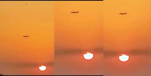 Breath Holding View of Sunset and Plane Flying By The Side of it