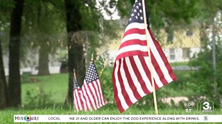 Volunteers place more than 8,600 flags at veteran gravesites