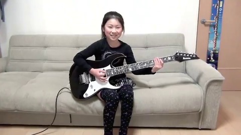 Cool girl playing electric guitar