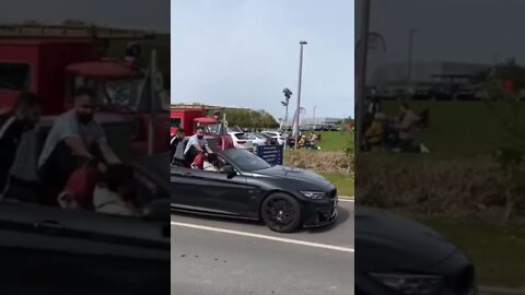 Guy Sitting On Car Takes An Epic Fall