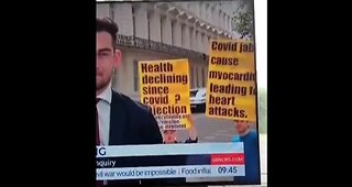 2 Truthers Highjack the News and Expose Death Jab With Protest Signs. Get Your Signs Ready