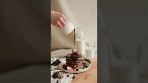 A Person Pouring Chocolate Syrup on Pancakes🥞🥞