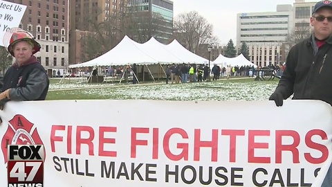 Police, firefighters protest plans to cut retiree health care benefits