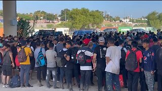 Enormous group of predominantly single adult men waiting to be processed by Border Patrol.