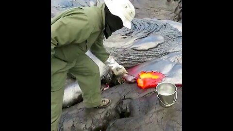 This is how geologists collect lava samples from an active volcano