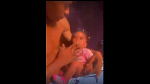 Guy gives his baby a smoke!