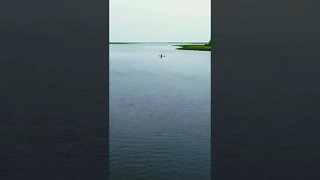 Flying drone out to kayak