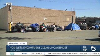 Garbage crews help clean up homeless encampment in Midway