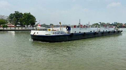 White container ship passing Koh Kret island at Chao Phraya river in Thailand