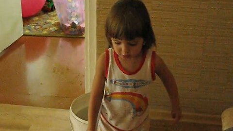 Little Girl Hilariously Takes A Tumble Into A Bucket Of Water