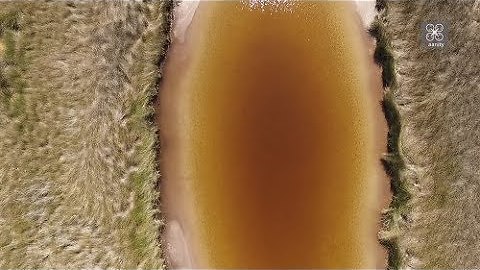 Drone view of "Crème caramel" lake and "ink lagoon" near Athens, Greece