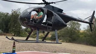 Pilot opens beer bottle with a helicopter