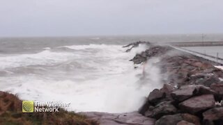 Angry sea grinds against the rocks on a gusty day