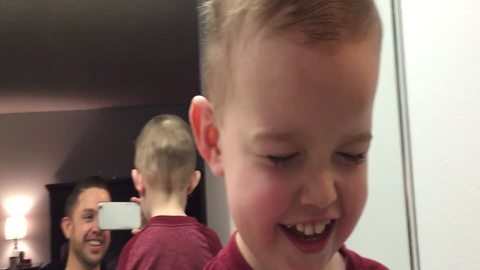 Adorable Boy Jokes Around with Dad