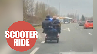 Police escort two people on mobility scooter riding pillion on A40