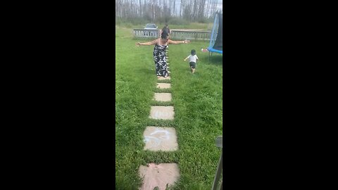 Toddler carefully rushes down the stairs, and around grandma to get to grandma!